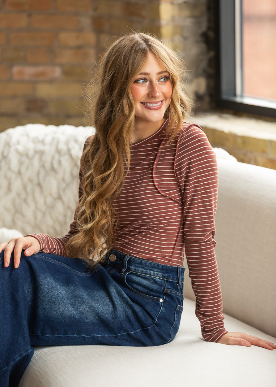 Maroon and cream striped fitted long sleeve top styled with a dark wash denim maxi skirt.