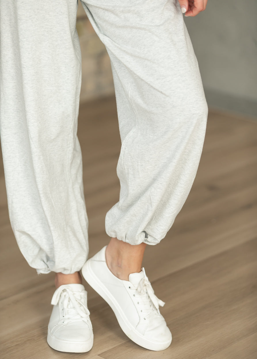 Heather gray loose fit jogger pants from the back with elastic ankle cuffs.