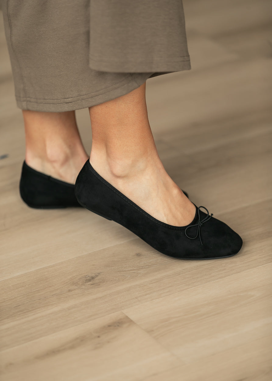Black MIA Tinna bow ballet flats styled with a neutral midi skirt for an everyday outfit.