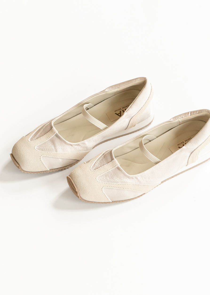 Soft ivory MIA Via Shimmer Flats angled to show tonal paneling, elastic straps, and sporty ballet-flat shape.