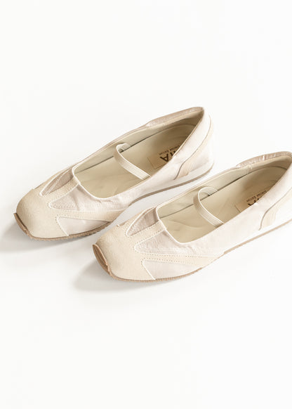 Soft ivory MIA Via Shimmer Flats angled to show tonal paneling, elastic straps, and sporty ballet-flat shape.