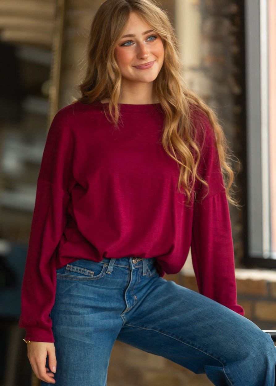 Maroon cotton modal top styled with medium wash wide leg jeans and neutral sneakers.