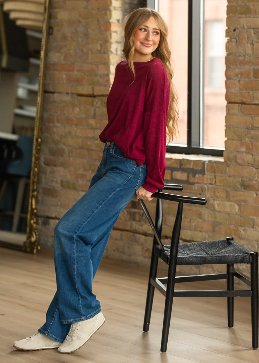 Maroon cotton modal long sleeve top with a loose fit, crew neckline, and drop shoulders.