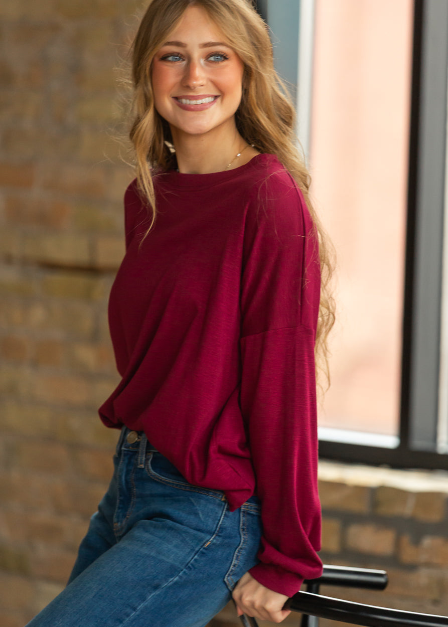 Close-up of maroon slub knit long sleeve top showing the soft texture and relaxed sleeve.