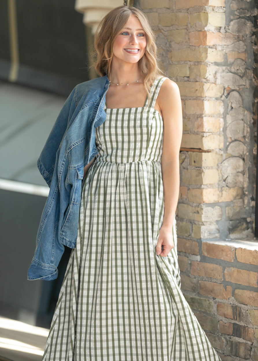 Sweet pea green gingham maxi dress with pockets and flowing maxi-length silhouette.