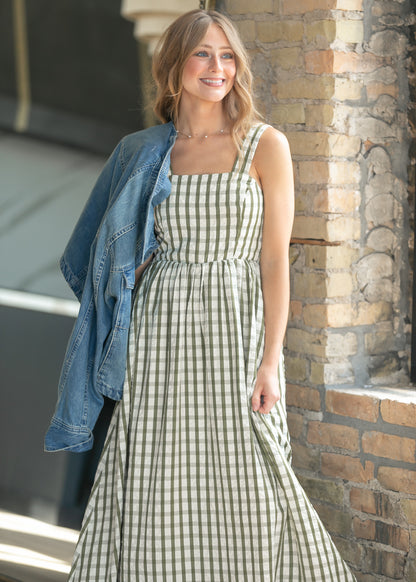 Sweet pea green gingham maxi dress with pockets and flowing maxi-length silhouette.