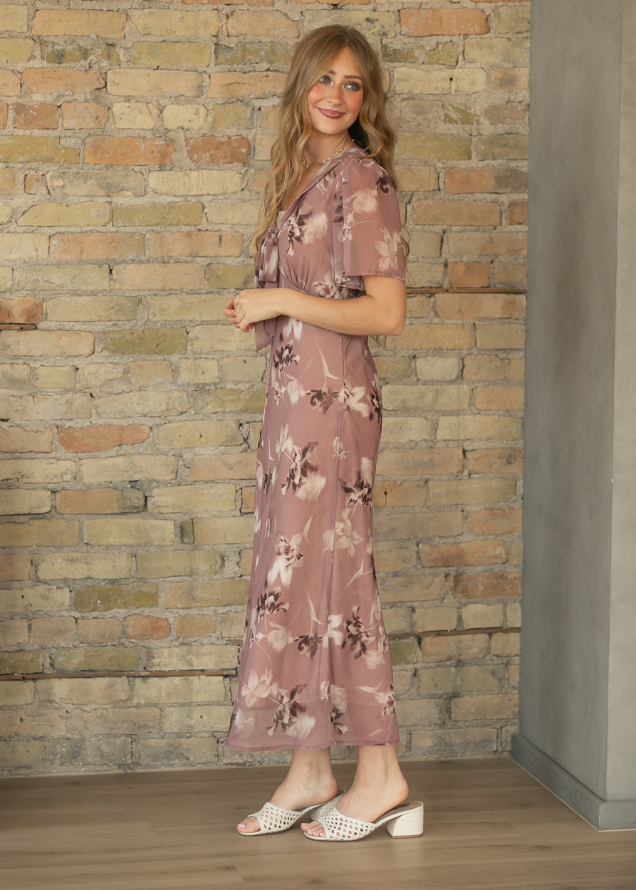 Full side view of mauve floral maxi dress with flowing ankle-length skirt, styled with cream slide heels.