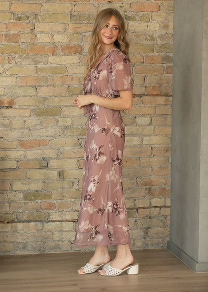 Full side view of mauve floral maxi dress with flowing ankle-length skirt, styled with cream slide heels.