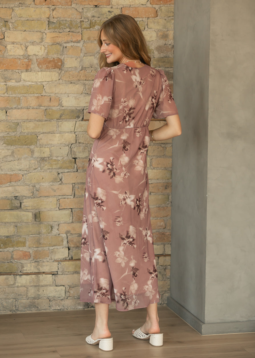 Back of mauve floral maxi dress showing the semi-fitted waist, short sleeves, and ankle-length hem.