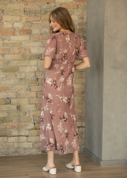 Back of mauve floral maxi dress showing the semi-fitted waist, short sleeves, and ankle-length hem.