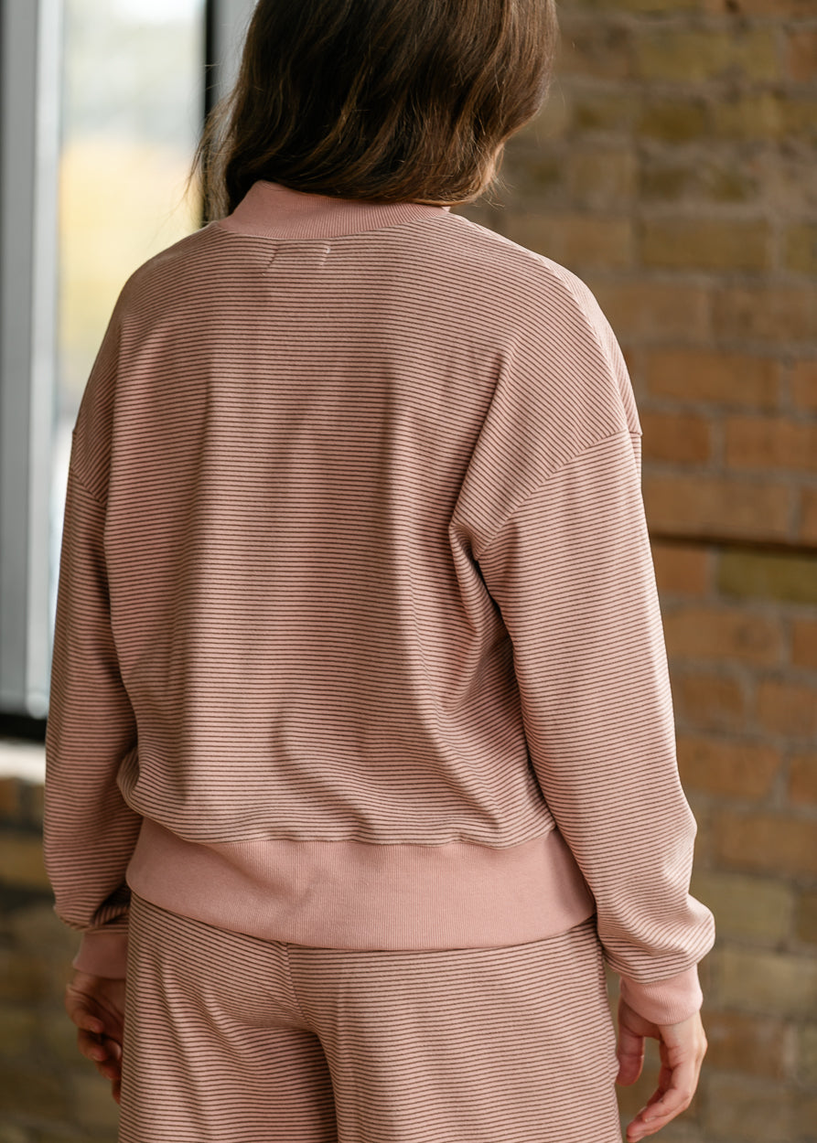 Back of mauve olive striped mock neck top showing the loose fit, dropped shoulders, and ribbed hem.