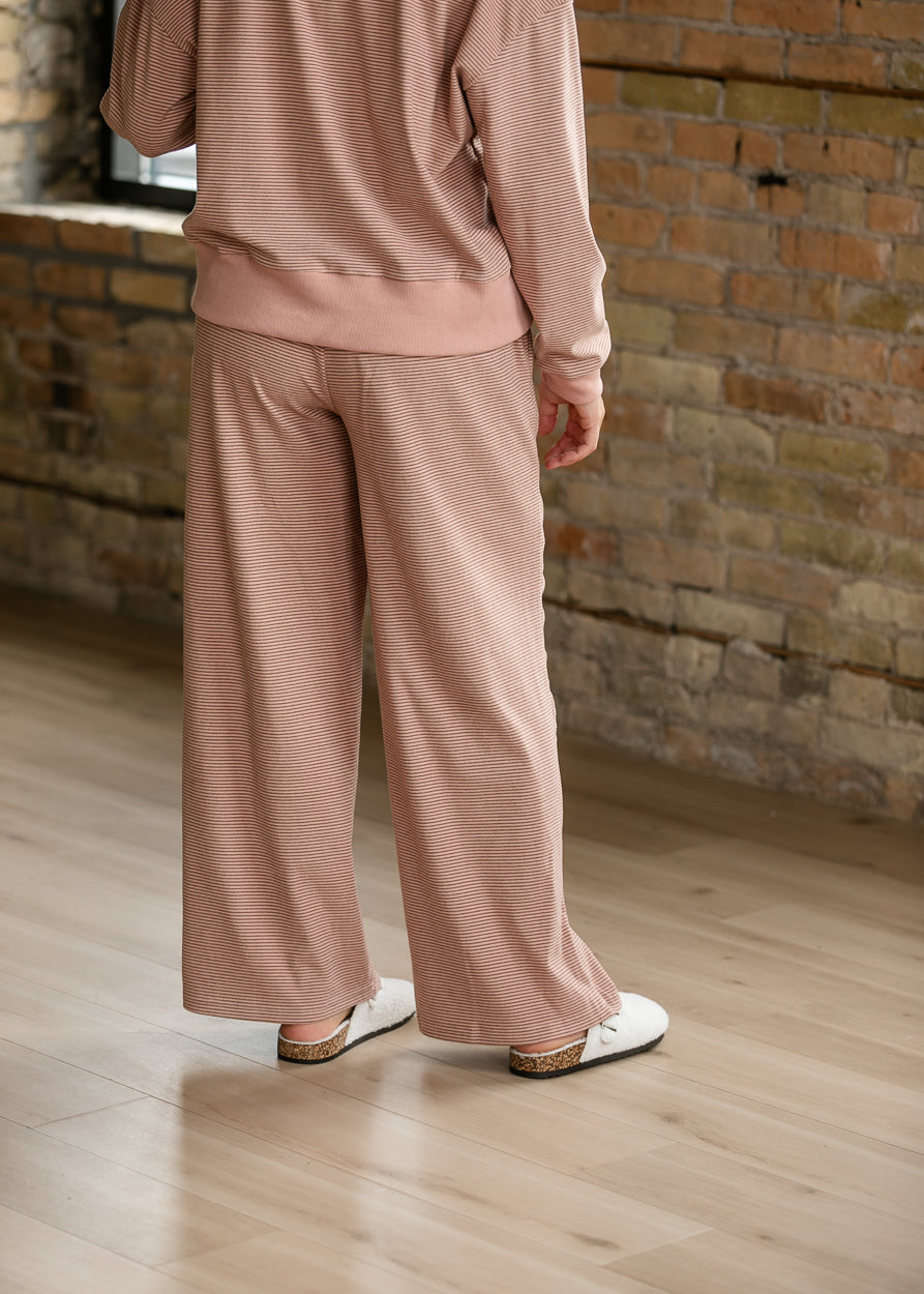 Back of mauve olive striped wide-leg pants showing the relaxed fit and ankle-length hem.
