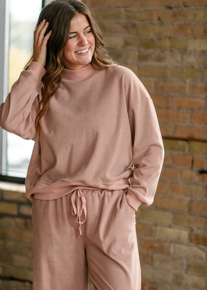 Mauve olive striped mock neck top with ribbed trim styled as part of a matching lounge set.