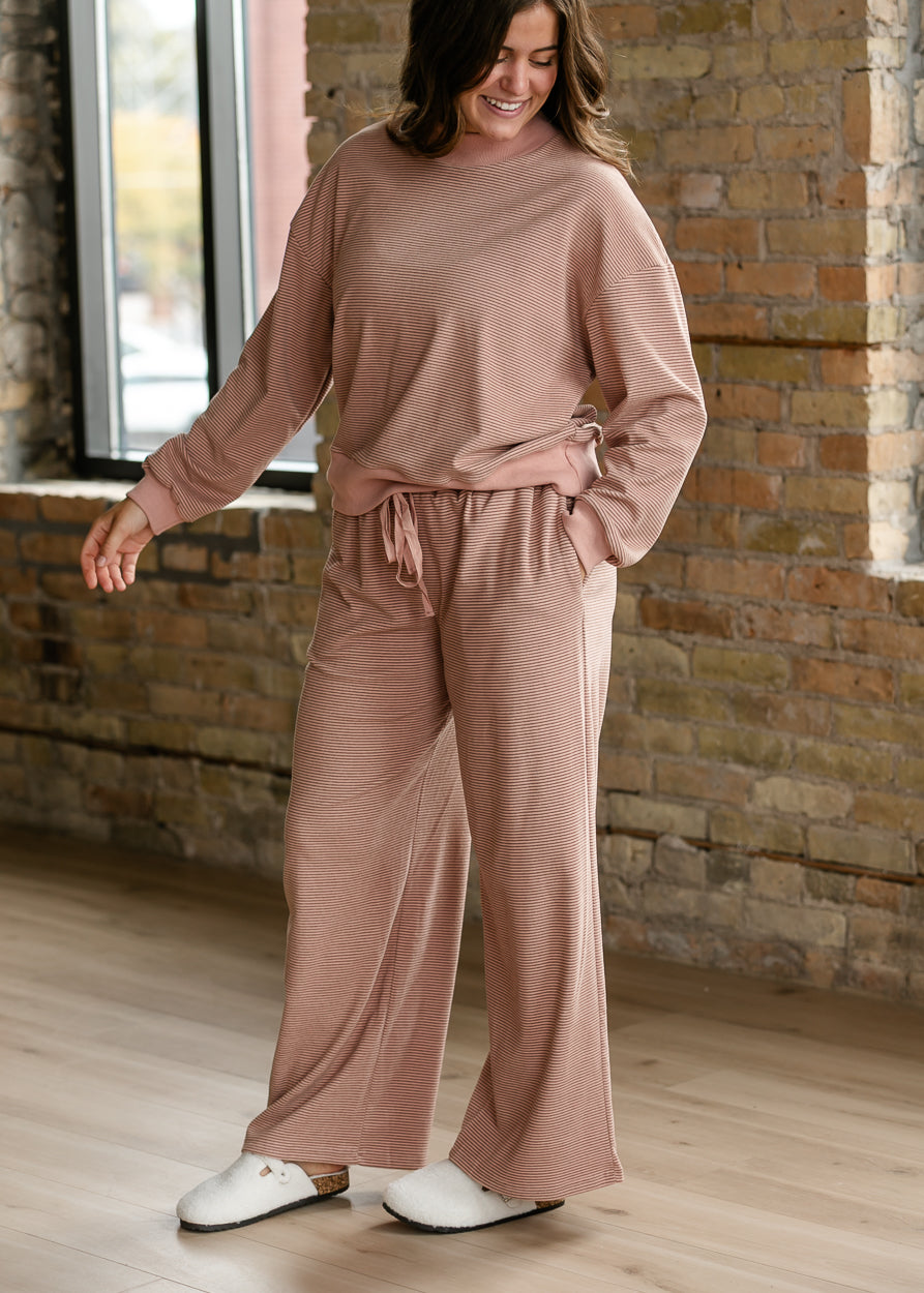 Mauve olive striped pants styled as a matching set with the coordinating long sleeve top.