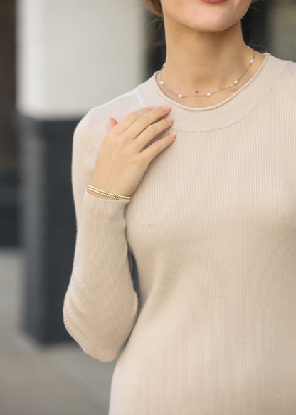 Close-up of the back neckline and ribbed knit texture of the taupe Mayra midi dress.