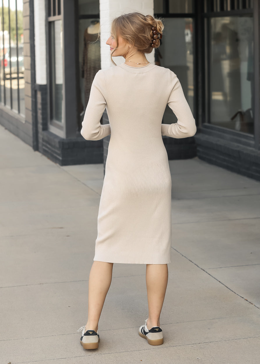Back of taupe ribbed midi dress showing the crew neckline, long sleeves, and fitted silhouette.
