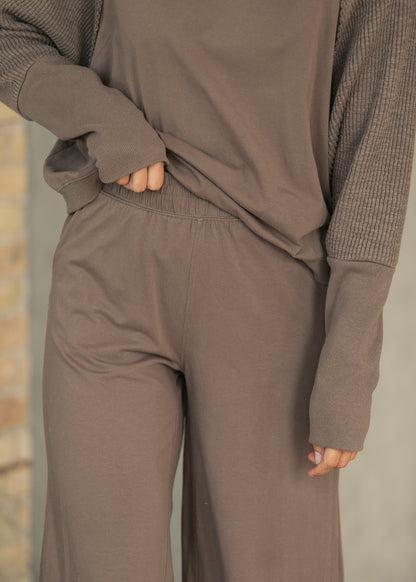 Mocha sweatshirt and wide leg pants set with elastic waistband, shown in a close-up of the waist and cuffs.