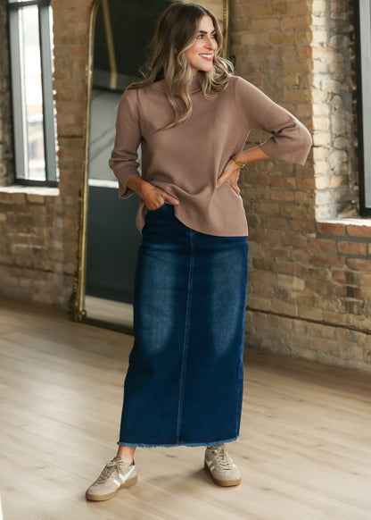 Dusty brown bell sleeve sweater styled with a dark wash denim maxi skirt and neutral sneakers.