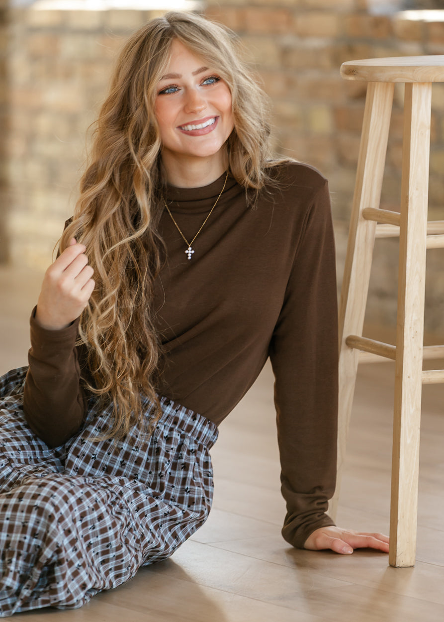 Mocha brown long sleeve mock neck top featuring a smooth knit finish and classic high neckline.