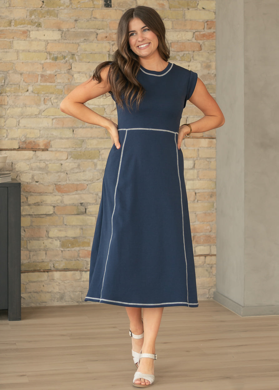 Navy contrast stitch midi dress with cap sleeves and A-line silhouette.