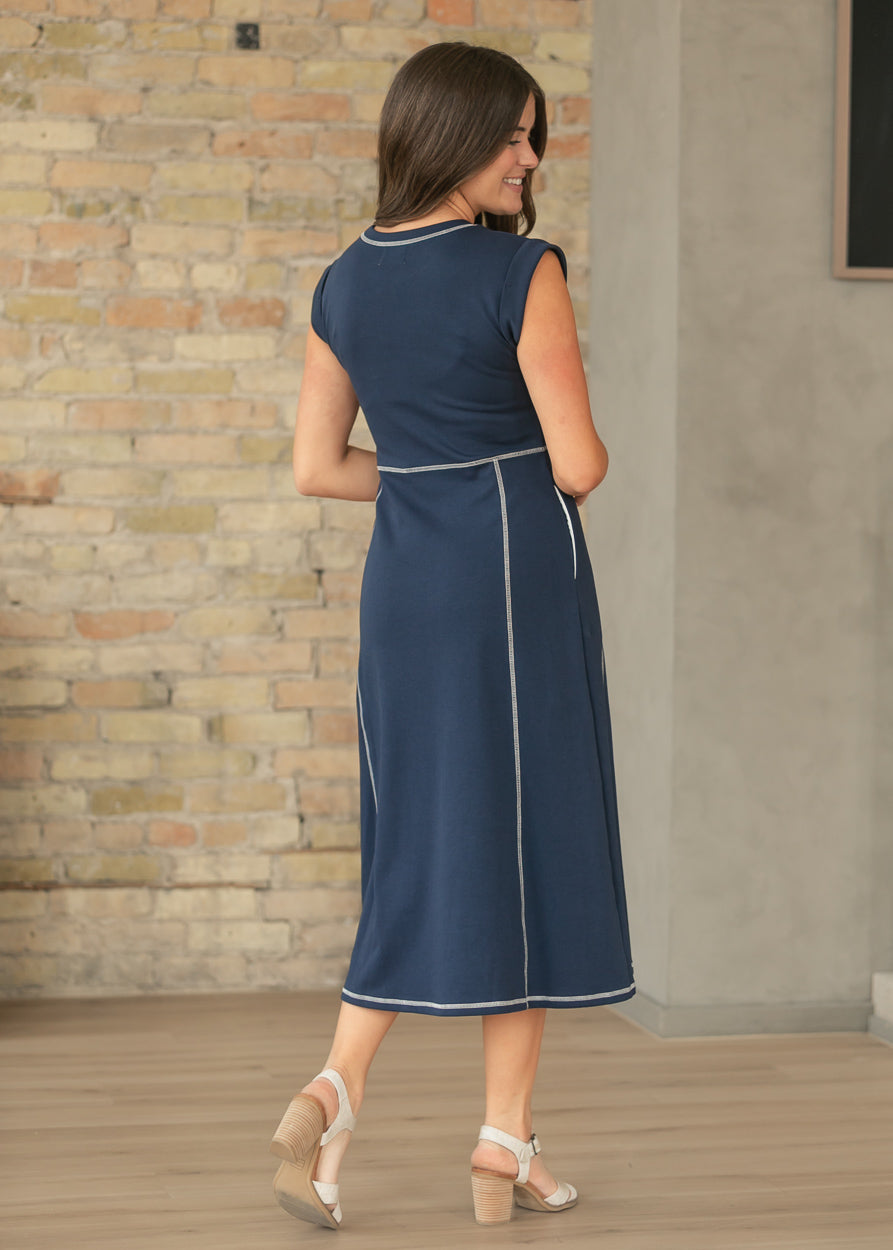 Back view of navy midi dress showing contrast stitch detailing and midi length.
