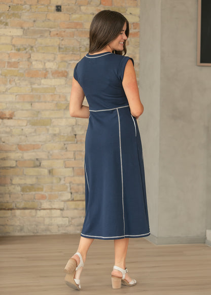 Back view of navy midi dress showing contrast stitch detailing and midi length.