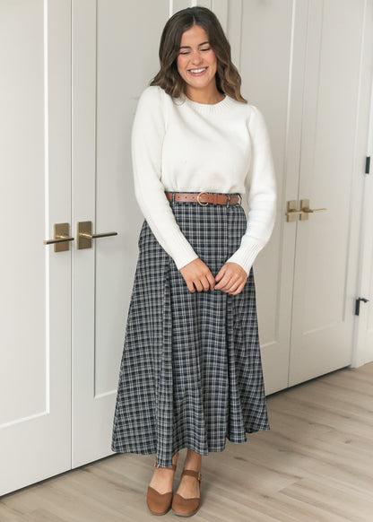 Navy plaid flare maxi skirt with coordinating brown belt, styled with an ivory sweater and flats.