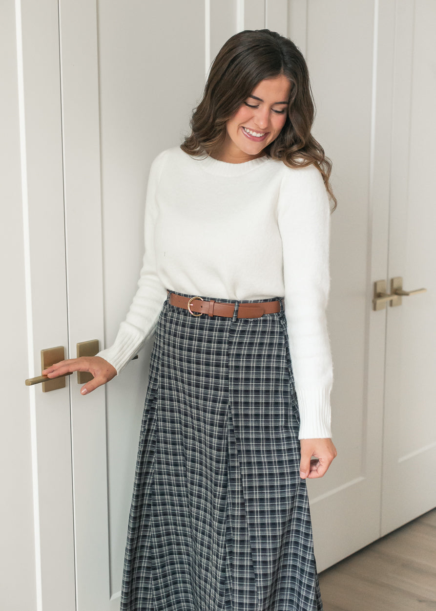 Navy plaid maxi skirt with classic check pattern, belted waist, and full flared shape.