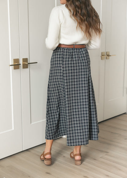Back of navy plaid flare maxi skirt showing the full silhouette and belted high waist.