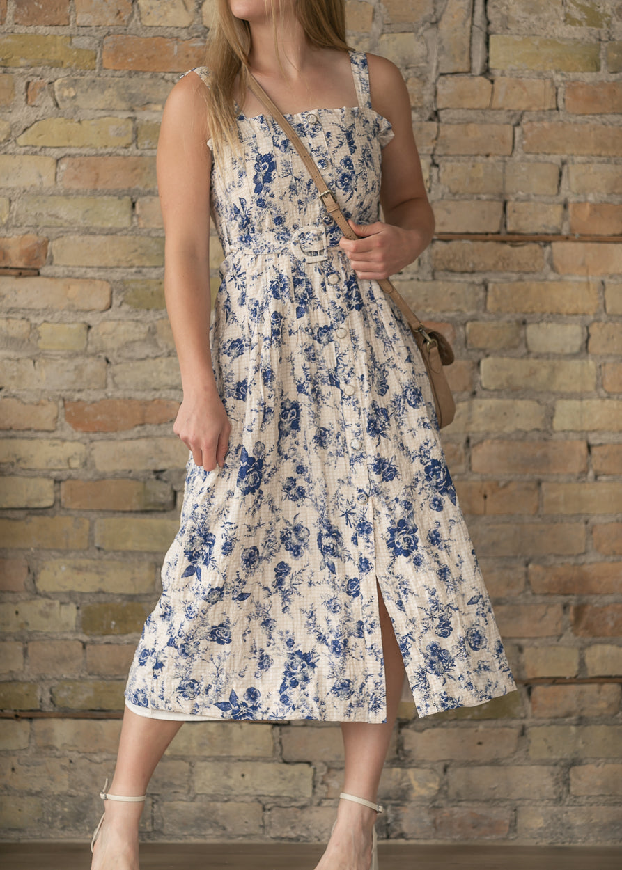 Sleeveless floral midi dress with belted waist and feminine silhouette