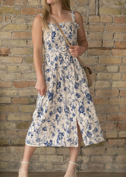 Sleeveless floral midi dress with belted waist and feminine silhouette