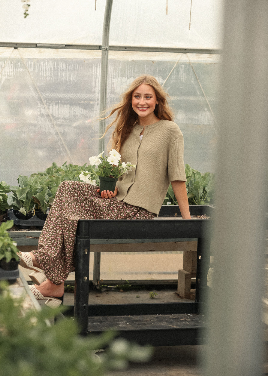Short sleeve taupe cardigan styled in greenhouse