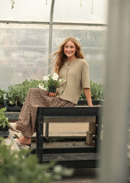 Short sleeve taupe cardigan styled in greenhouse