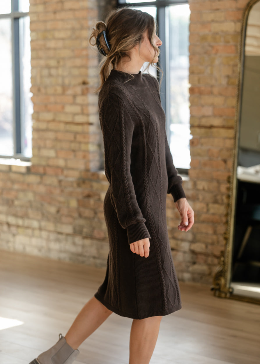 Chocolate cotton sweater dress with a mock neck, textured knit pattern, and long sleeves with ribbed cuffs.