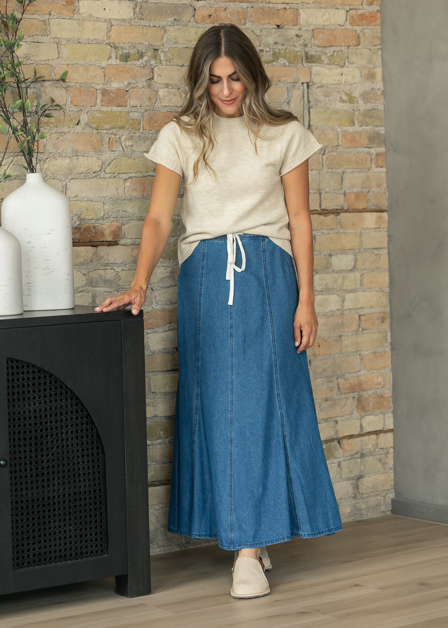 elan Sam Stone crewneck sweater styled with a paneled blue denim maxi skirt.