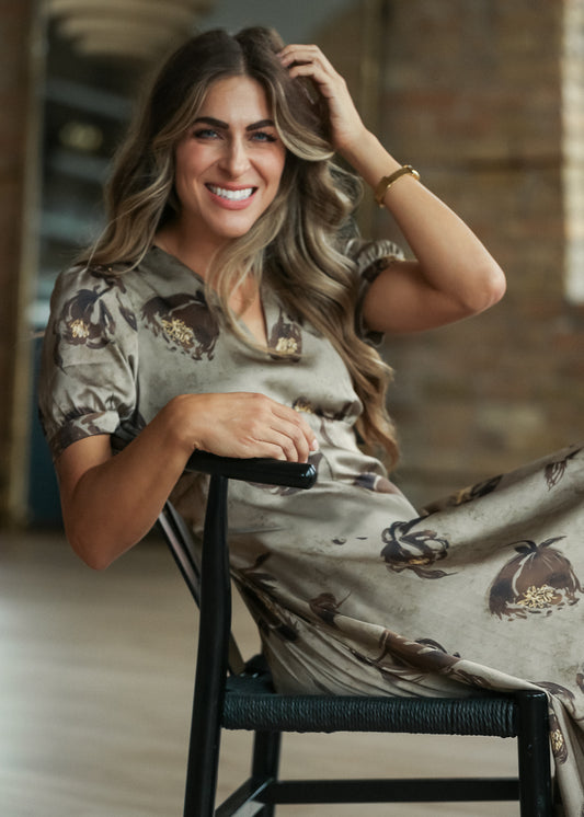 Olive satin floral midi dress with short sleeves, V-neckline, and dark brown floral print.