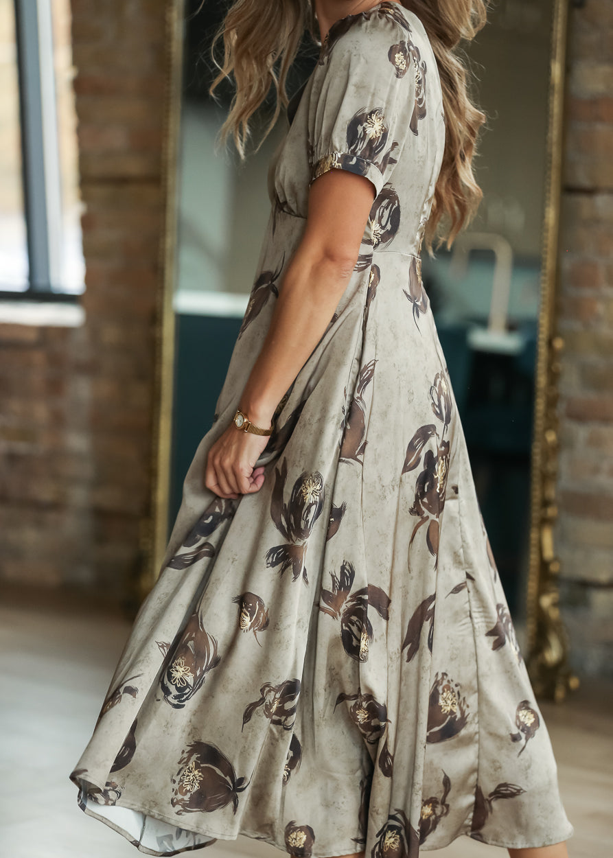 Olive satin printed midi dress with dark brown floral pattern and cream heels.