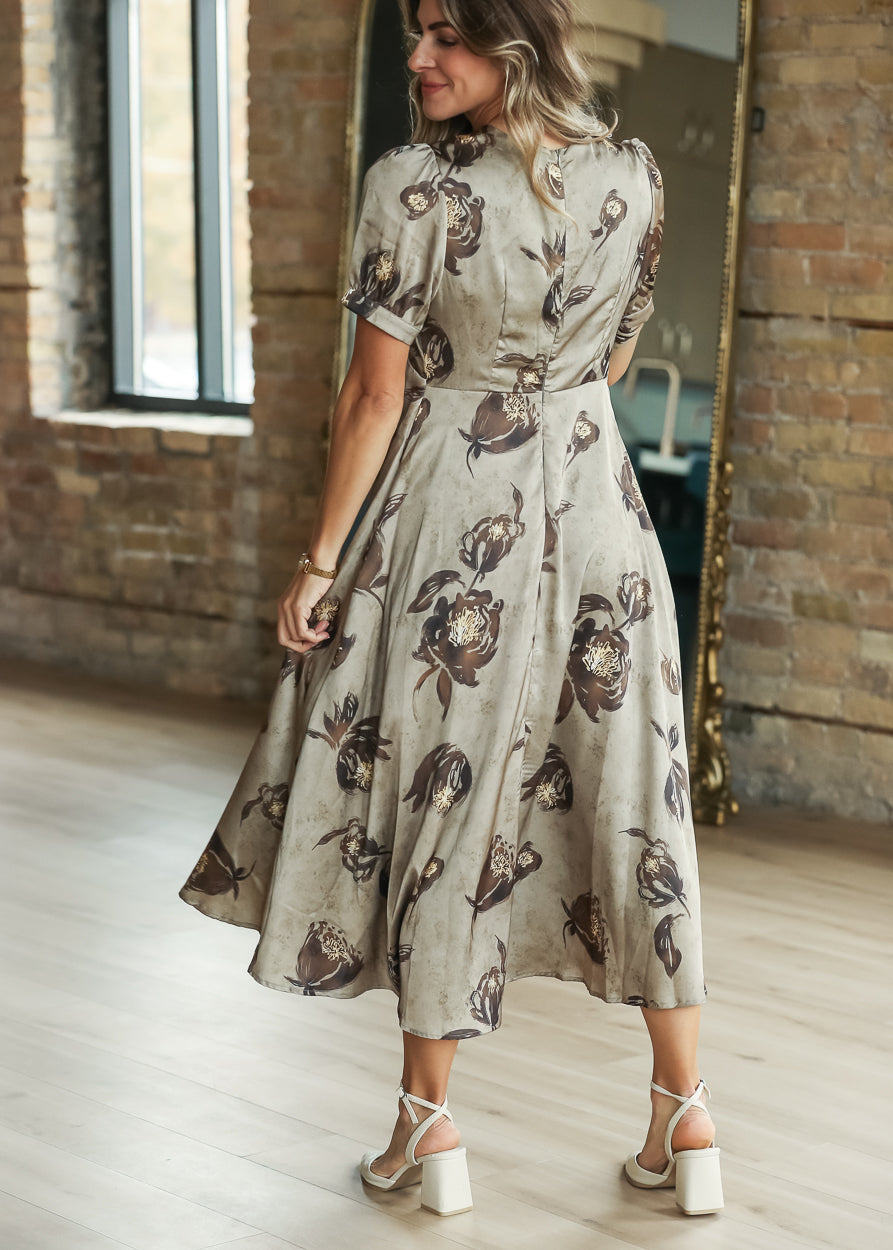 Olive satin floral midi dress styled with cream heels for an elevated occasion look.