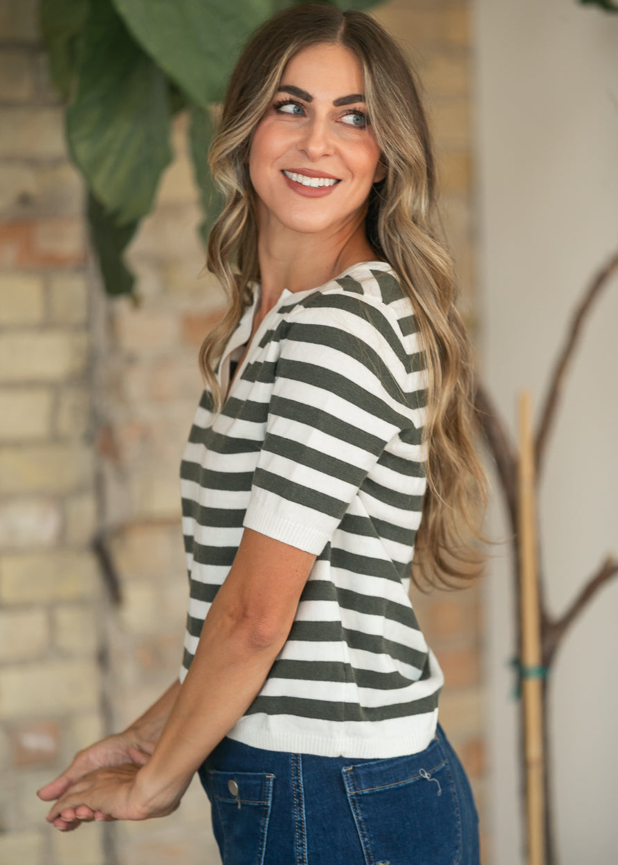 Side view of the striped knit top with short sleeves and a relaxed, semi-fitted shape.