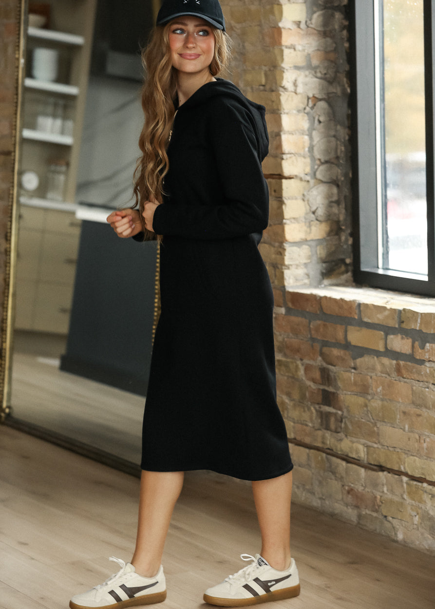 Full-length black quarter-zip sweatshirt with oversized fit and longline silhouette.