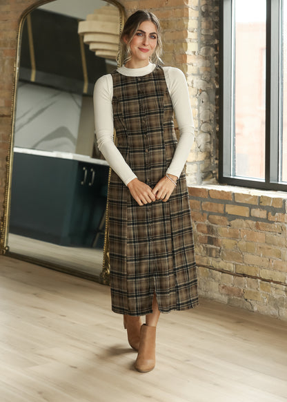 Brown plaid sleeveless midi dress showing the full-length plaid pattern and semi-fitted shape.