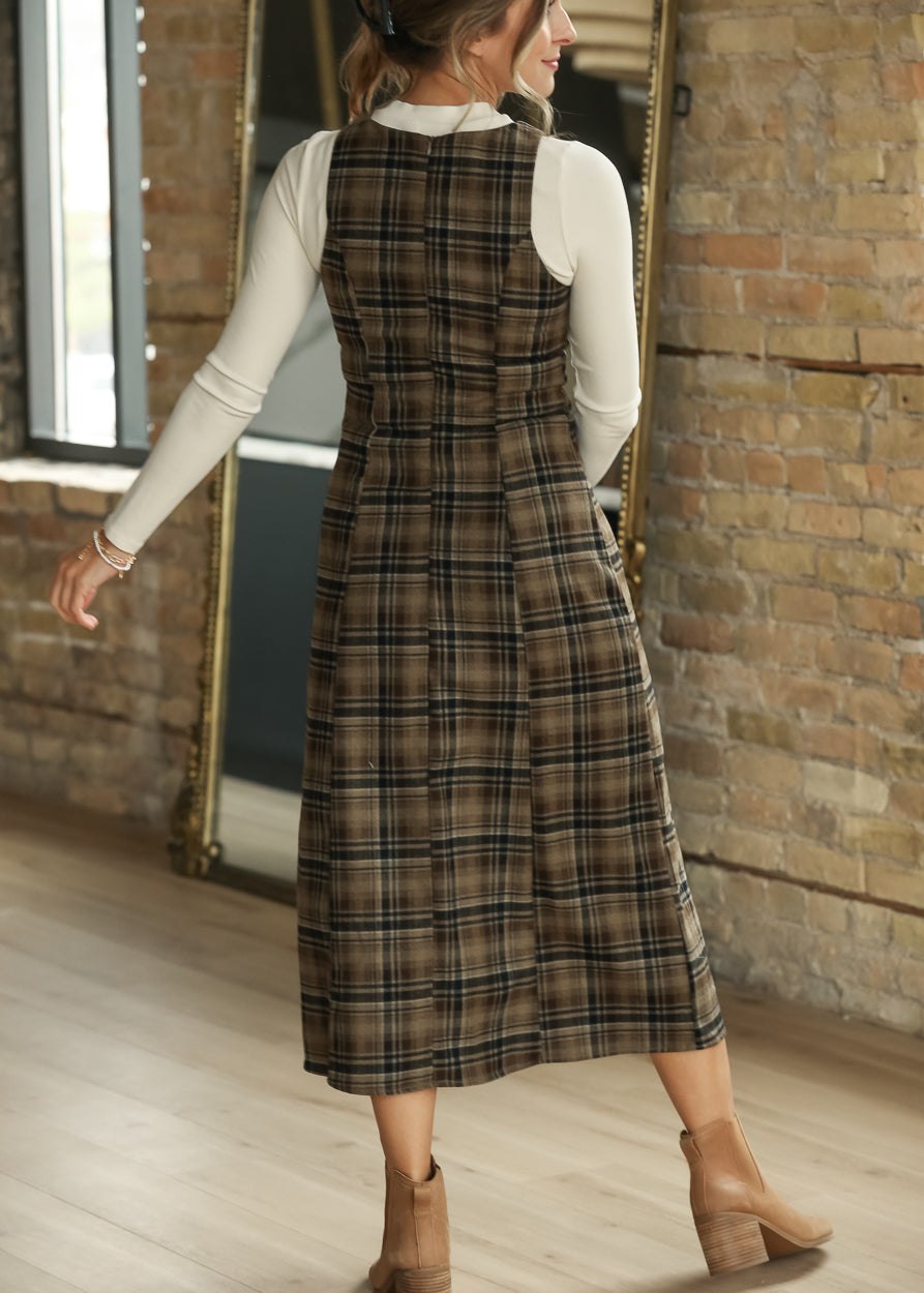 Back of brown plaid midi dress layered over an ivory long sleeve top, showing the semi-fitted shape.