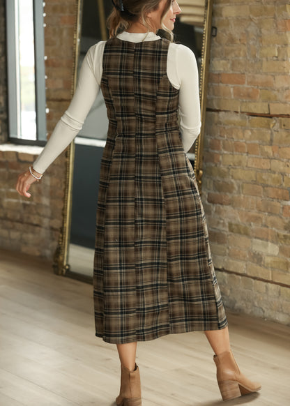 Back of brown plaid midi dress layered over an ivory long sleeve top, showing the semi-fitted shape.