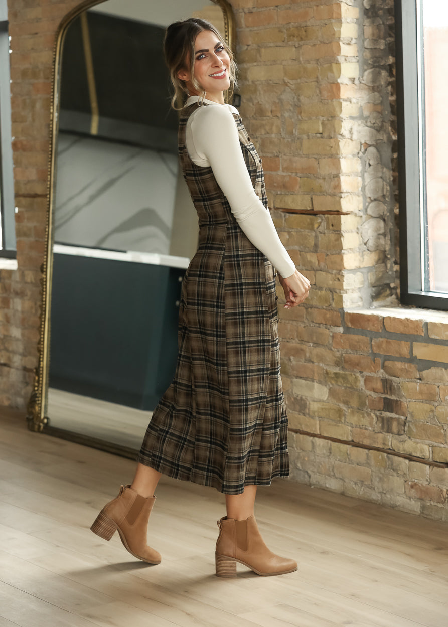 Brown plaid sleeveless midi dress from the back with a softly flared midi skirt.