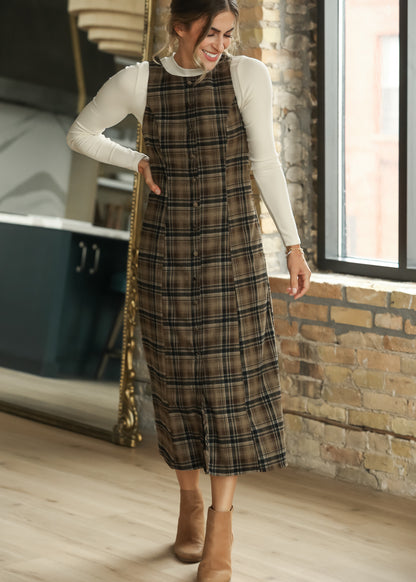 Brown plaid midi dress showing decorative button front and full midi-length silhouette.