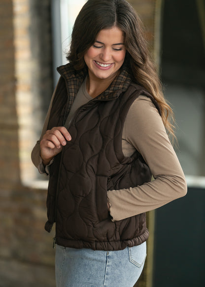 Brown quilted vest with functional front pocket and zip closure