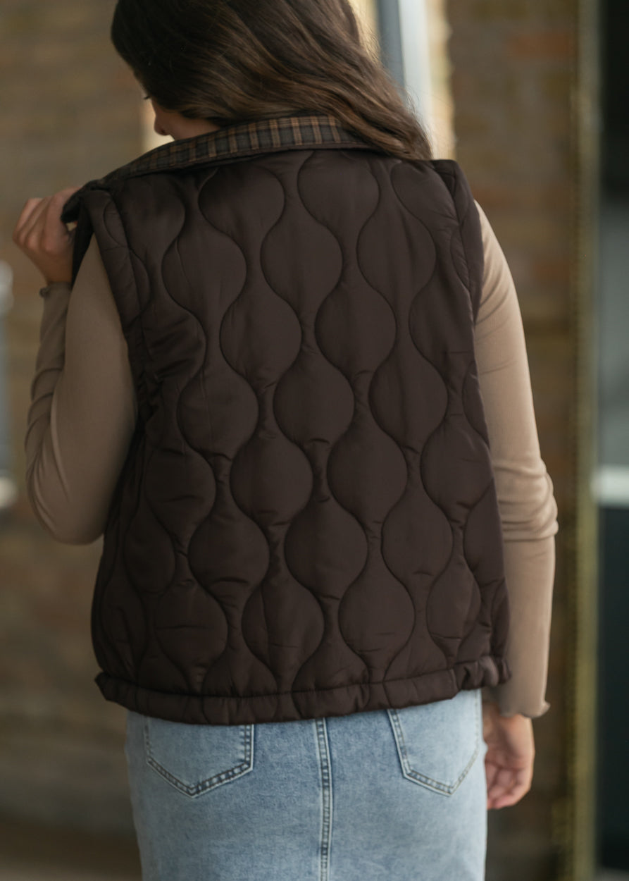 Back view of brown quilted vest with plaid collar and curved quilting Inherit_Co_Brand_Voice_Product_…