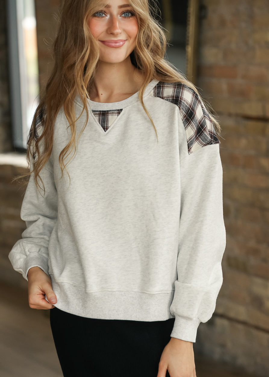 White mélange sweatshirt with brown plaid shoulder panels and matching plaid neckline inset.