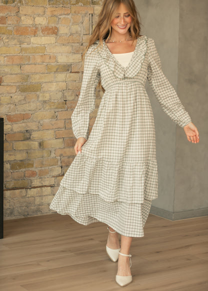 Plaid ruffled midi dress with a flowing tiered skirt and elasticized empire waist in a full-length view.