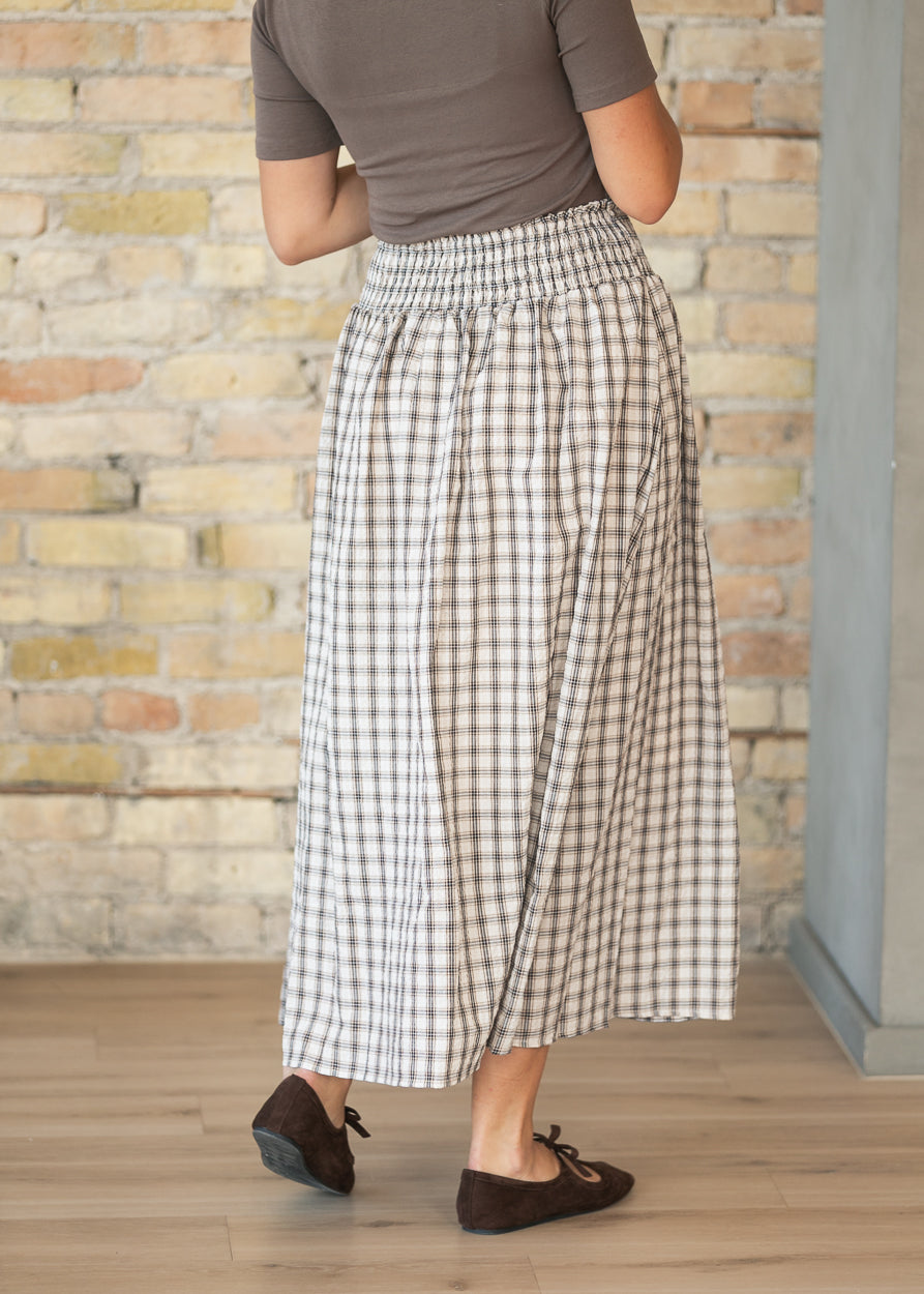 Back of cream plaid midi skirt showing the wide smocked waistband and softly gathered skirt.